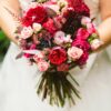 a bride is carrying a bouquet