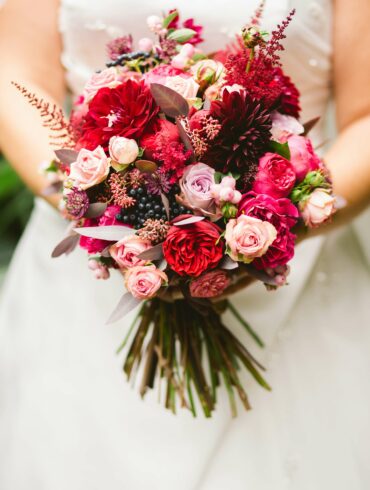 a bride is carrying a bouquet
