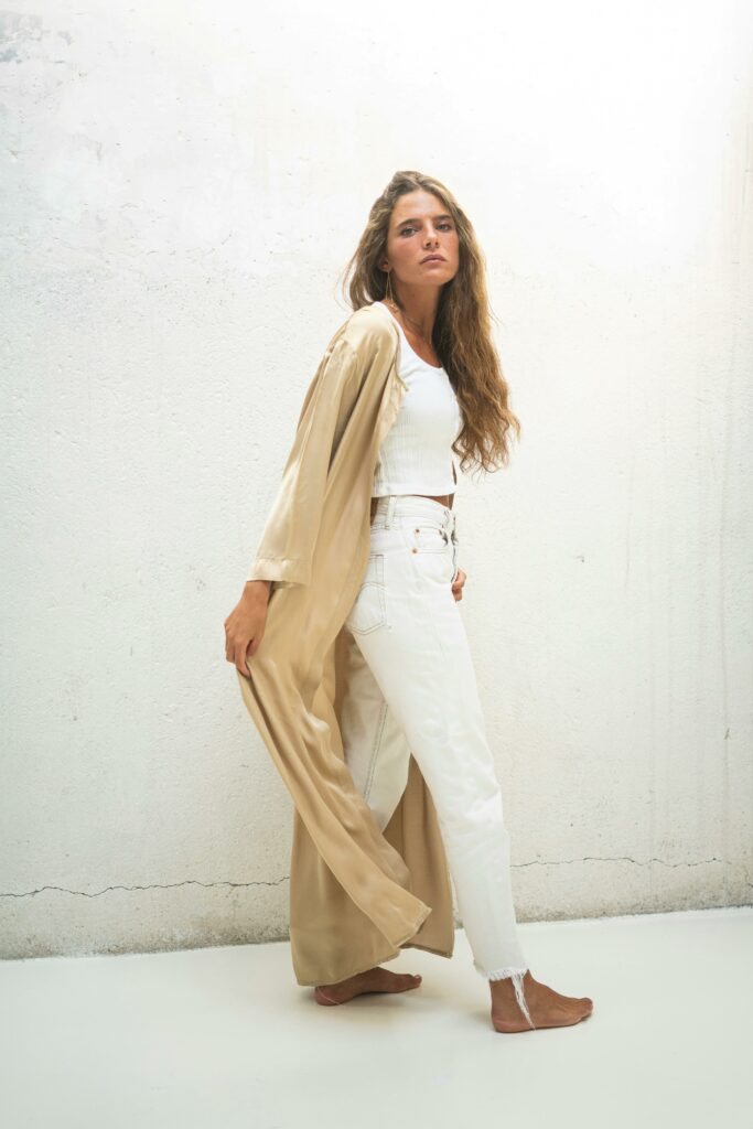 Woman in WhiteCrop Top and White Pants with Beige Outerwear
