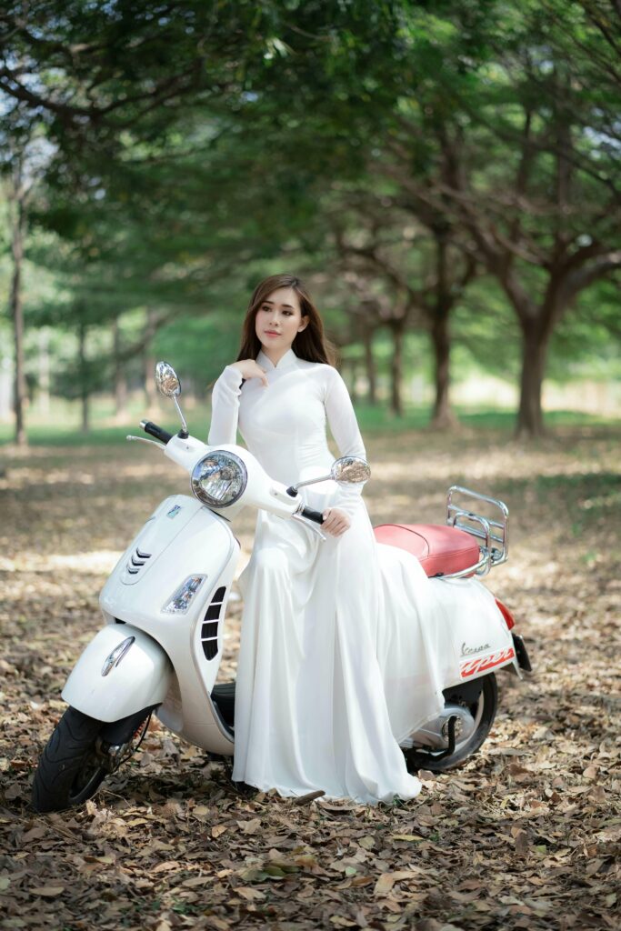 woman in bridal dress on scooter