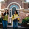 College Girl Walking with Their Notes and Smiling