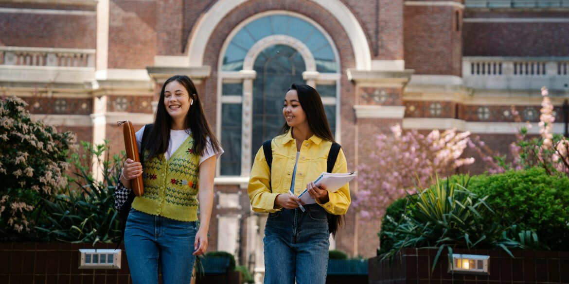 College Girl Walking with Their Notes and Smiling