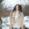 woman in pink long sleeve shirt and white skirt standing on snow covered ground during daytime